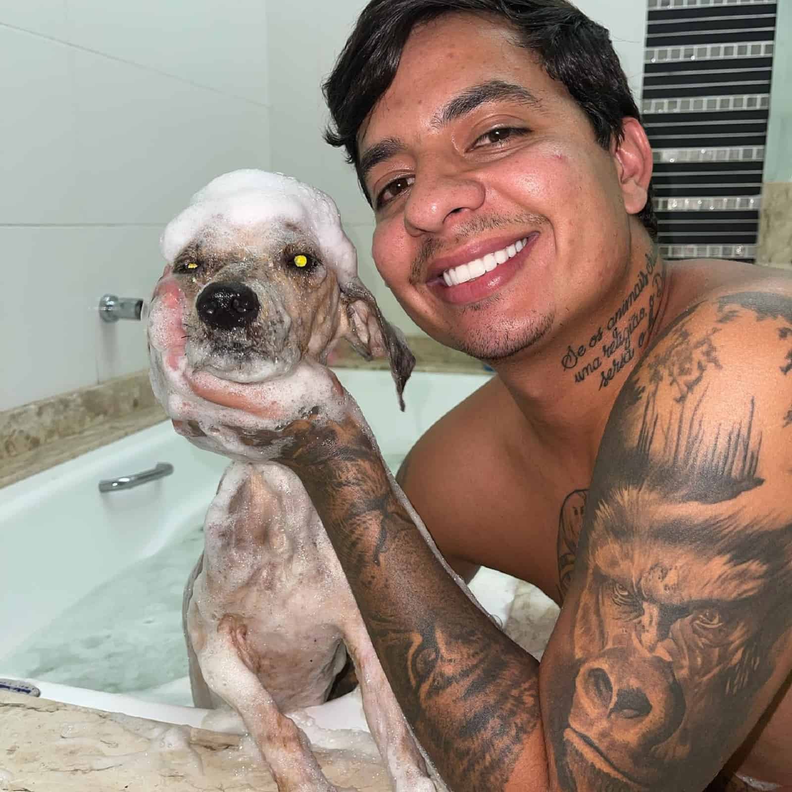 Man bathing a puppy for the first time